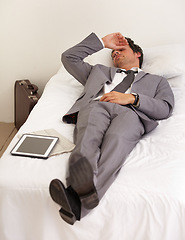 Image showing Burnout, depression and tired business man in bed with mental health crisis, mistake or stress at home. Anxiety, fatigue or workaholic in bedroom with headache, vertigo or digital alarm clock fail