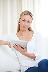 Image showing Mature woman, tablet and thinking in home, serious face and living room couch. Social media, technology and communication for scrolling, vision and idea with connection, streaming and contemplating