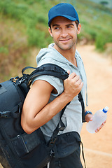 Image showing Water, hiking and smile with man in nature for health, trekking and summer adventure. Travel, explore and journey with person walking in mountain path for backpacking, relax and wellness vacation