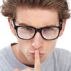 Image showing Secret, face and man in studio for sign of privacy, noise and confidential trust on white background. Portrait, guy with glasses and finger on lips for quiet, gossip news and mystery emoji to whisper