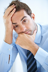 Image showing Portrait, stress and serious businessman with anxiety in a financial or accounting agency. Frustrated, depressed and face of a male person or accountant with stock market crash and worry or doubt