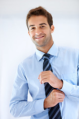 Image showing Businessman, portrait and happy or dressing with shirt, professional or employee at corporate job. Entrepreneur, face and person for smile, confidence and pride with calm expression or hands at work