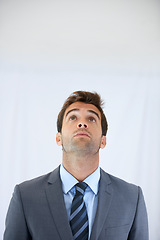 Image showing Thinking, looking up and business man in studio with options, decision and brainstorming ideas. Corporate, professional career and worker for problem solving, solution and choice on white background