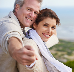 Image showing Mature couple, portrait and outdoor on vacation, airplane hands and happiness for holiday. Man, woman and bonding together with smile, marriage and commitment with affection, seaside and joyful