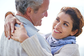 Image showing Couple, smile and hug in outdoors, travel and bonding or love, affection and security in relationship. Mature people, happy and relaxing on vacation, holiday and adventure or getaway, embrace or care