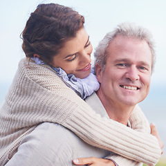 Image showing Mature couple, love and piggy back in outdoor, romantic and happiness for holiday fun. Man, woman and bonding together with smile, marriage and commitment with affection, joyful and blue skies