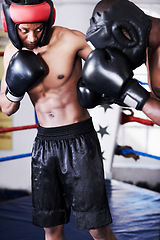 Image showing Boxing, man and sparring partner in ring together with headgear, gloves and fitness, power training, challenge. Strong body, fighting hit and boxer in helmet, fearless and confident in competition.