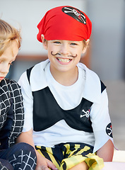 Image showing Portrait, halloween and a boy in a pirate costume for a trick or treat tradition outdoor in his neighborhood. Kids, smile and a happy young male child in a fantasy outfit for holiday celebration