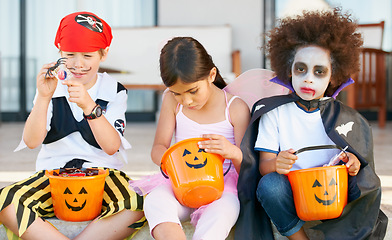 Image showing Children, halloween and candy bucket for holiday fun or vampire dress up, fairy or pirate role play. Friends, group and pumpkin basket as dessert or trick or treat celebration, fantasy or development