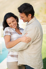 Image showing Couple, happy and flirting with embrace, honeymoon and joy with smile, young and connect. Marriage, outdoor and love for commitment, bonding together and care for romantic relationship, man or woman