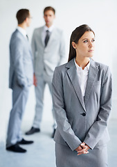 Image showing Businesswoman, serious and thinking for future in law career, standing and ready for job. Worker, corporate attorney in suit and professional in workplace, colleagues in background and confident