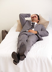 Image showing Depression, bed and tired business man with burnout, stress or mistake or mental health crisis at home. Anxiety, fatigue or male workaholic in bedroom with headache, vertigo or frustrated by insomnia