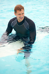 Image showing Confident, man or surfer in ocean with board, health fitness or happy in summer with water sports. Person, smile and relax wellness in caribbean beach with vacation, adventure and wetsuit for workout