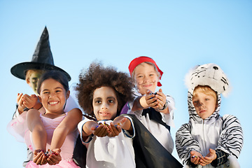 Image showing Children, hands and portrait for halloween costume for sweet candy asking, trick or treat for fantasy. Friends, group and dress up as witch or pirate for holiday, kid development on sky background