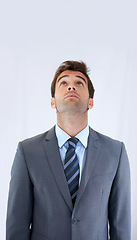 Image showing Thinking, looking up and business man on a white background for options, decision and brainstorming ideas. Corporate, professional career and worker for problem solving, solution and choice in studio