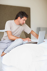 Image showing Working, man in bedroom and laptop to work from home, smiling and sitting in bed for freelance job. Technology, Entrepreneur and remote worker for online job, company and marketing projects