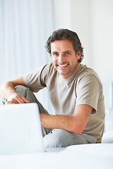 Image showing Portrait, happy man in bedroom and laptop to work from home, smiling and sitting in bed for freelance job. Technology, Entrepreneur and remote worker for online job, company and marketing projects