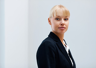 Image showing Portrait, confidence and business woman in office, workplace or corporate company on mockup space in Switzerland. Serious face, professional female agent and entrepreneur, worker and employee in suit