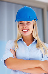 Image showing Architecture, portrait of happy woman with confidence and helmet for safety on construction site. Civil engineering, project management and property development, female contractor with arms crossed.