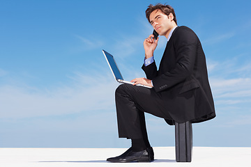 Image showing Laptop, phone call and business man on briefcase in conversation, listening or communication on blue sky mockup space. Computer, mobile chat and serious lawyer networking, discussion or legal advice