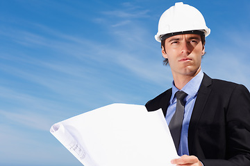 Image showing Industry, blueprint and construction worker thinking by blue sky on building rooftop for planning. Engineering, professional and male industrial employee with architecture drawing for project.