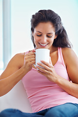 Image showing Relax, coffee break and woman in house for thinking, resting or enjoying peaceful moment, day off or me time. Face, smile and female person in a living room with tea, calm or weekend freedom chilling