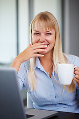Image showing Portrait, coffee and happy woman in office with laptop, market research or online website review. Businesswoman at desk with drink in cup, professional admin career and laughing at startup agency.