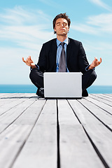 Image showing Laptop, meditation and a business man outdoor on a pier by the ocean for mindfulness or stress relief for job. Computer, yoga and a young corporate employee by the sea for remote work or balance