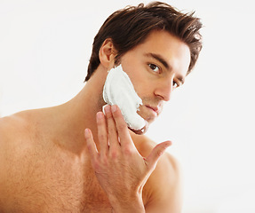 Image showing Shaving, cream and face of man in morning, grooming routine and hair removal in bathroom. Cosmetics, beauty and hand with foam, soap or person with self care in home for wellness of skin and body