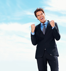 Image showing Business man, fist pump and smile for success, celebration and excited for achievement or victory. Happy businessperson, promotion and bonus or salary increase, opportunity and blue sky background