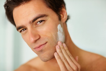 Image showing Portrait, skincare and cream with a man in the bathroom of his home for morning routine or treatment. Face, beauty and lotion with a person in his apartment to apply moisturizer for skin hydration