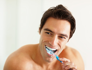 Image showing Bathroom, brushing teeth and man with oral health, wellness and grooming routine for fresh breath. Person, home or guy with toothbrush, cleaning his mouth and morning with dental hygiene or self care