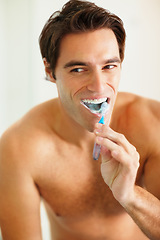 Image showing Bathroom, brushing teeth and man with oral hygiene, wellness and grooming routine for fresh breath. Person, home or guy with toothbrush, cleaning his mouth and morning with dental health or self care