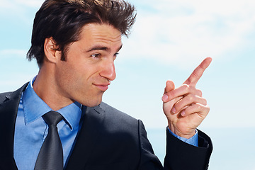 Image showing Face, pointing and a corporate man on a blue sky background planning with a vision for the future. Business, thinking or idea and a confident young employee in a suit with a mindset for growth