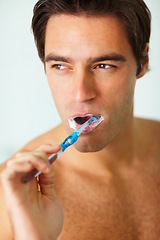 Image showing Bathroom, brushing teeth and man with thinking, dental hygiene and grooming routine for fresh breath. Person, home or guy with toothbrush, cleaning his mouth and morning with oral health or wellness