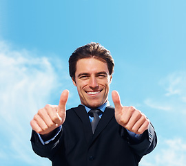 Image showing Businessman, thumbs up and portrait for success, support or like emoji on blue sky background for real estate. Face of professional realtor, business man or corporate agent for good job, okay or yes