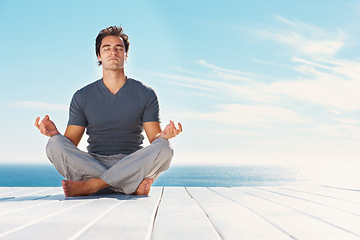 Image showing Yoga, blue sky and relax man meditate for spiritual mindset healing, chakra energy balance or outdoor summer freedom. Mockup mindfulness space, beach patio and yogi peace, calm and zen for wellness