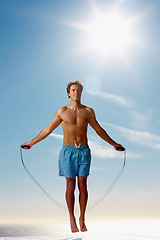 Image showing Man, shirtless or rope skipping for fitness in summer workout, muscle or happy on vacation. Model, smile or training for natural glow of sport, cardio exercise or sunshine holiday by sky background