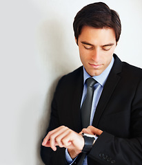 Image showing Time, watch and a young business man in studio on a white background for delay while waiting for an appointment. Schedule, late and impatient with male employee in a suit for professional work