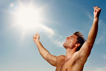 Image showing Freedom, hands raised and a shirtless man on a blue sky with flare for fresh air in summer during vacation. Health, fitness and winner with the body of a confident young person outdoor for wellness