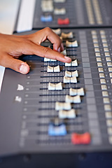 Image showing Recording studio, hand and mixing on sound board with dj, technology and media on desk. Music, editing or person with equipment for audio, production and moving switch on console for radio or song
