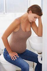 Image showing Vomiting, pregnant woman and morning sickness in bathroom, nausea and uncomfortable. Mirror reflection, moody and frustrated with illness, pregnancy and struggling with migraine pain on sink