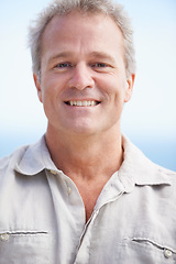 Image showing Mature, man and happy portrait on holiday at beach with freedom, adventure or retirement. Smile, outdoor and face of senior person on vacation to relax on cruise with blue sky, background or closeup