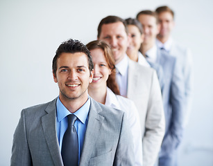 Image showing Happy man, portrait and leader with team in row, workforce, and ready for hiring process. Worker, corporate accountant in suit and professional in workplace, people in background and confident