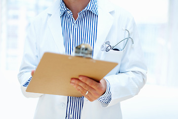 Image showing Hands, clipboard and man doctor a hospital for planning, schedule or surgery checklist closeup. Healthcare, compliance and male surgeon zoom with admin for insurance, documents or results analysis