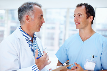 Image showing Healthcare, doctor and nurse with a clipboard, advice and communication with test results, career and wellness. Staff, medical and professional with documents, conversation or talking with physician