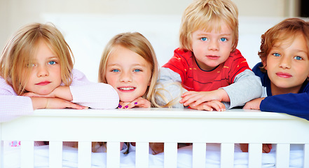 Image showing Portrait, smile or love with boy and girl sibling children on a bed in their home together. Family, happy or bonding with young brother and sister kids in the bedroom of an apartment on the weekend