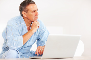 Image showing Thinking, morning and mature man on laptop for email, social media or streaming subscription on sofa. Internet search, couch and senior person on computer, website or networking ideas in living room.