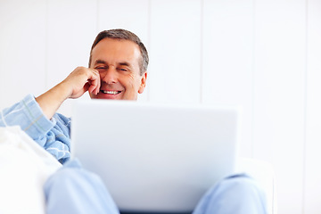 Image showing Bathrobe, relax and sofa, happy man on laptop for email, social media or streaming subscription in home. Internet search, couch and senior person on computer, website or networking in living room.