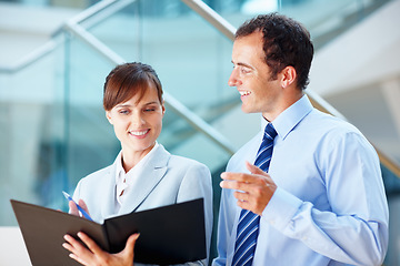 Image showing Business people, documents and teamwork with folder, planning budget and financial report in lobby. Corporate manager, woman or employees reading paperwork, bookkeeping or revenue proposal for advice